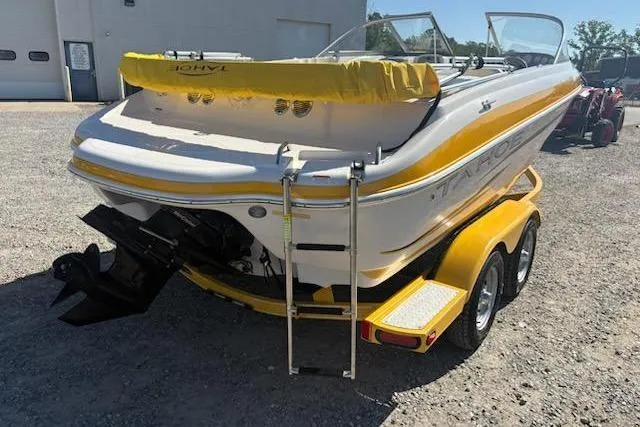 Slide: The Image of 2008 Tahoe Q6 Sport boat with yellow accents on a trailer, parked outdoors. - 4