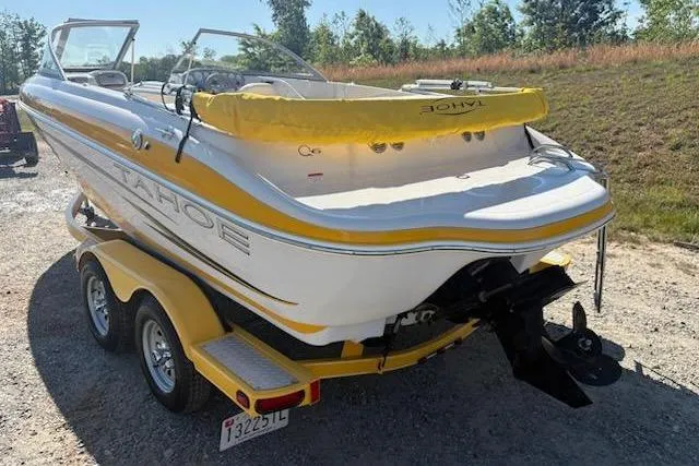 Slide: The Image of 2008 Tahoe Q6 Sport boat on trailer, yellow and white design, parked outdoors. - 5
