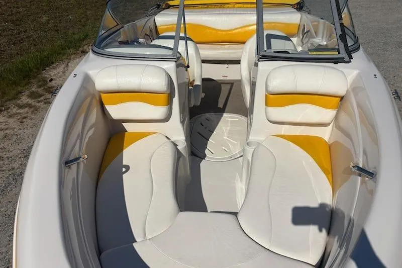 Slide: The Image of 2008 Tahoe Q6 Sport boat interior with white and yellow seating, open bow design. - 6
