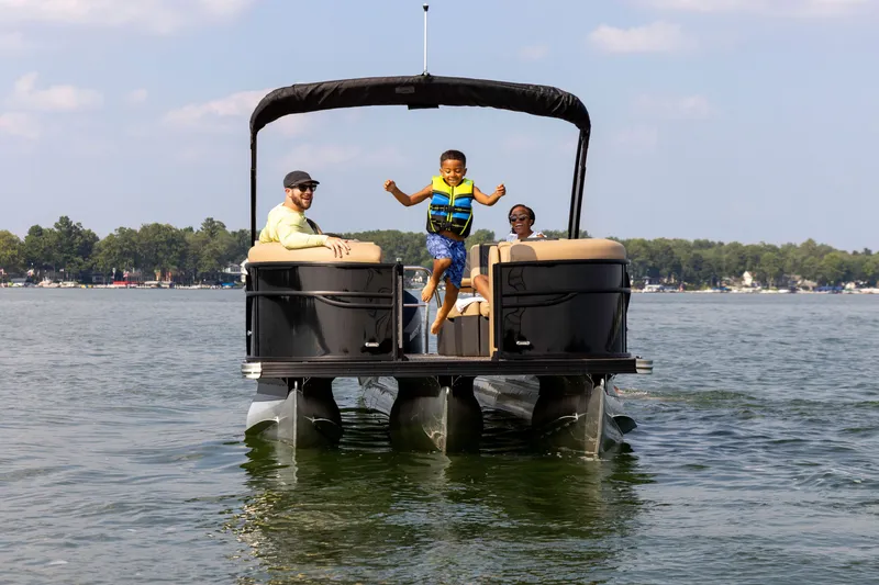 Slide: The Image of Family enjoying Barletta Cabrio 24 M on the water. - 1