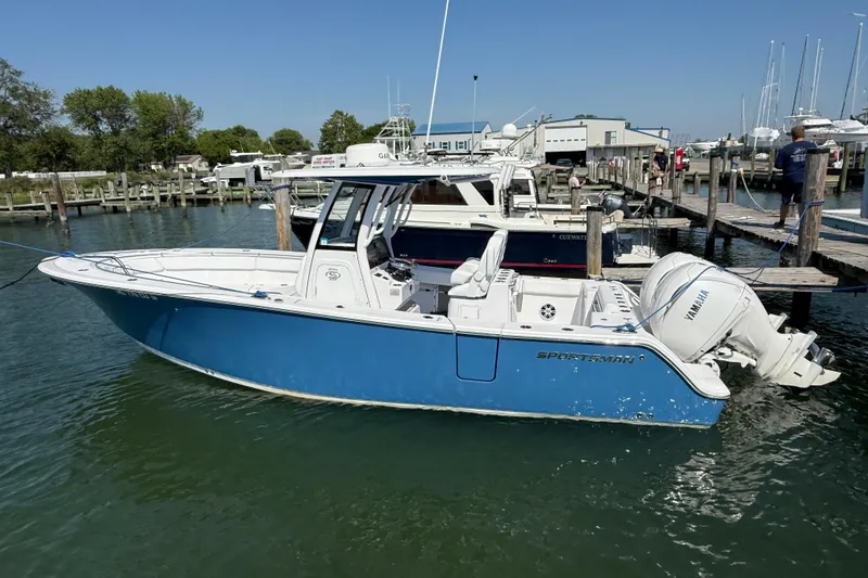 The Image of 2024 Sportsman Open 262 Center Console boat docked in marina. - 1