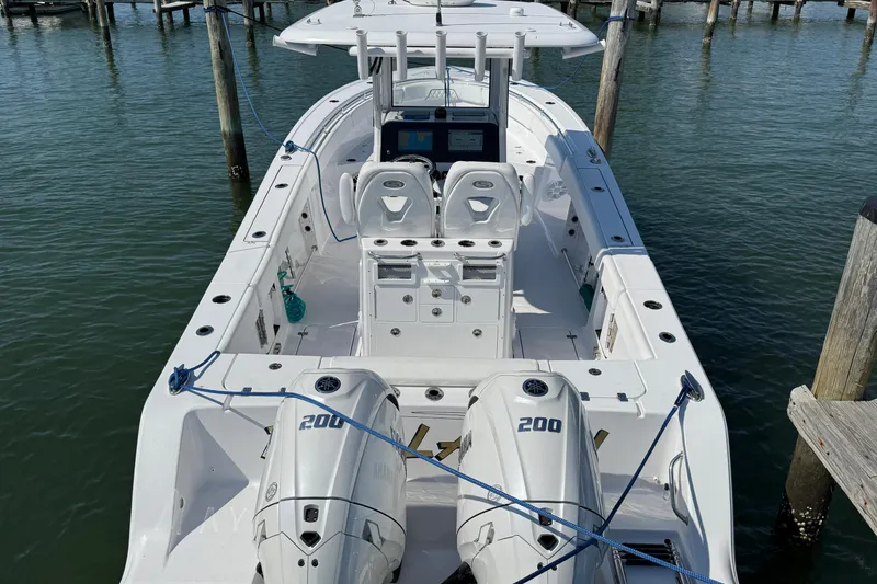 Slide: The Image of 2024 Sportsman Open 262 Center Console boat docked, featuring dual 200 horsepower engines. - 11