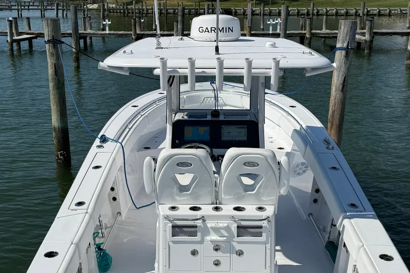 Slide: The Image of 2024 Sportsman Open 262 Center Console boat docked, featuring Garmin electronics. - 12