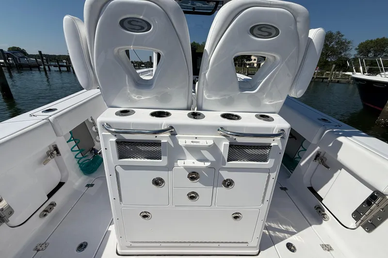 Slide: The Image of 2024 Sportsman Open 262 Center Console boat interior with seating and storage compartments. - 14