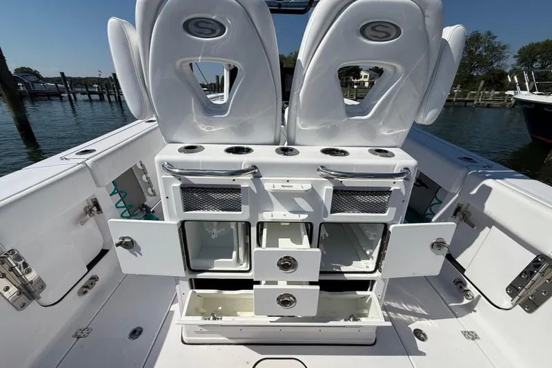 Slide: The Image of 2024 Sportsman Open 262 Center Console boat interior with storage compartments open. - 15