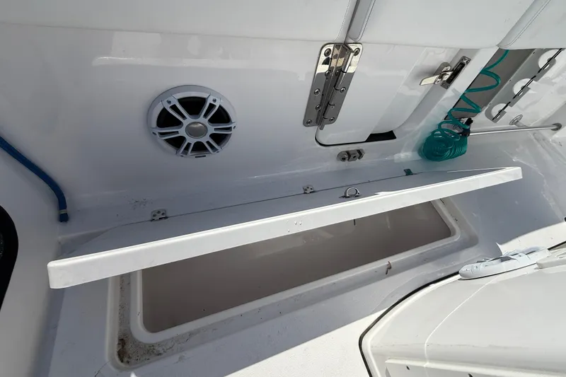 Slide: The Image of 2024 Sportsman Open 262 Center Console boat interior with storage compartment and speaker. - 18