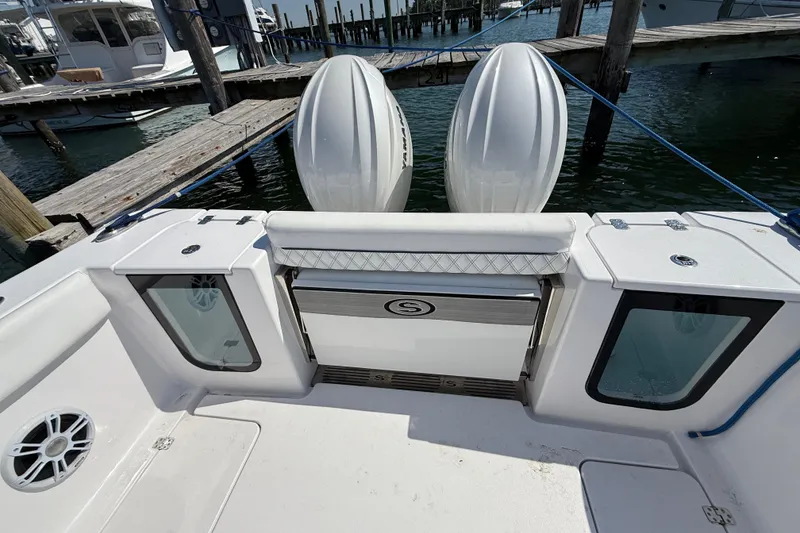 Slide: The Image of 2024 Sportsman Open 262 Center Console boat at dock with twin engines. - 19