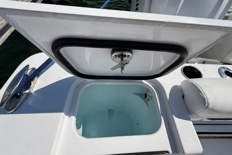 Slide: The Image of Open livewell on 2024 Sportsman Open 262 Center Console boat, docked with blue rope. - 22