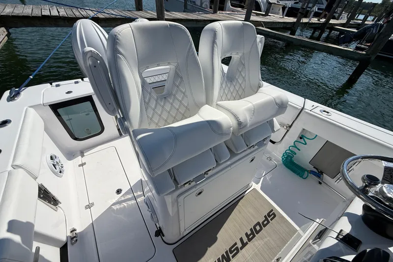 Slide: The Image of 2024 Sportsman Open 262 Center Console boat with luxurious white seating and modern design. - 25