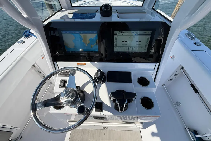 Slide: The Image of 2024 Sportsman Open 262 Center Console helm with dual displays and steering wheel. - 26
