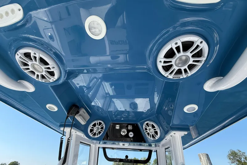 Slide: The Image of 2024 Sportsman Open 262 Center Console boat with blue ceiling and integrated speakers. - 27