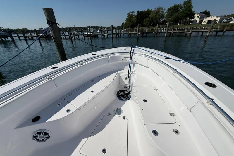 Slide: The Image of 2024 Sportsman Open 262 Center Console boat docked at a marina. - 28