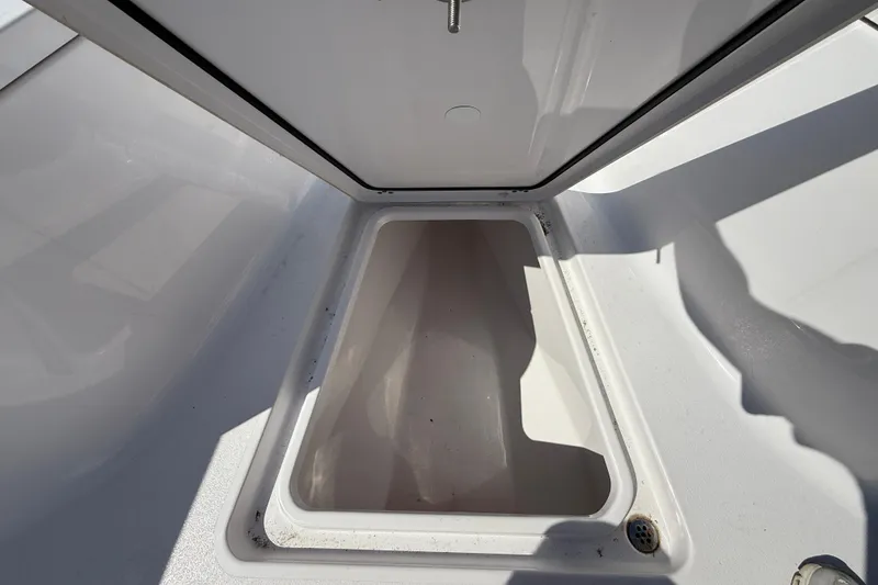 Slide: The Image of Open storage compartment on 2024 Sportsman Open 262 Center Console boat. - 33