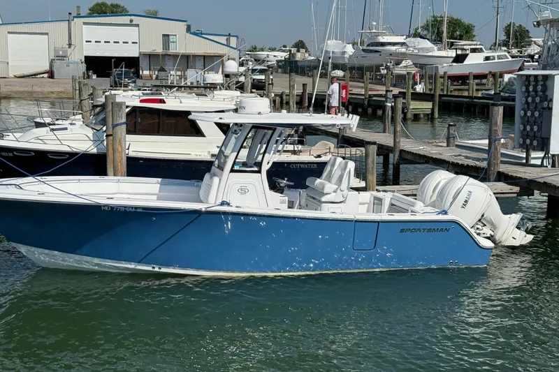 Slide: The Image of 2024 Sportsman Open 262 Center Console boat docked at marina. - 37