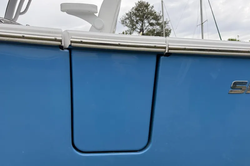 Slide: The Image of 2024 Sportsman Open 262 Center Console boat, blue hull detail with logo. - 8