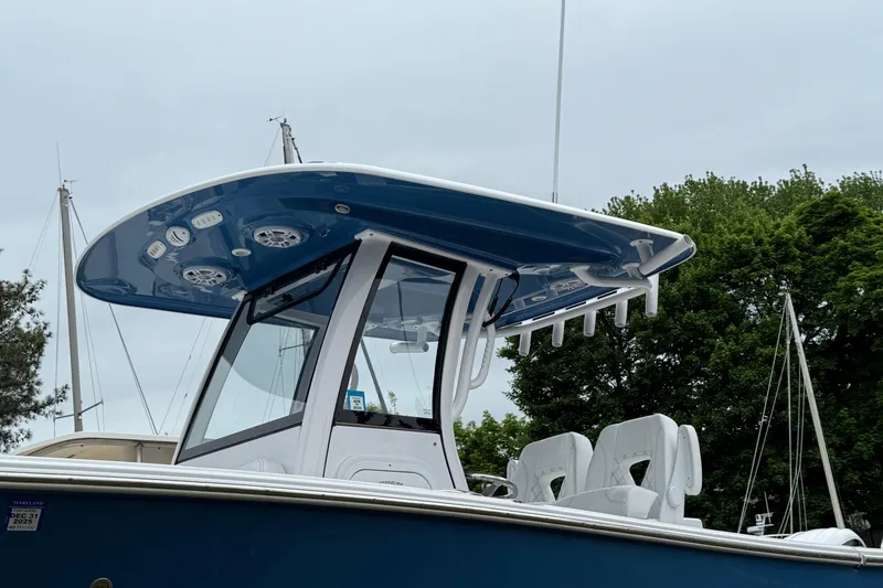 Slide: The Image of 2024 Sportsman Open 262 Center Console boat with blue T-top and seating. - 9