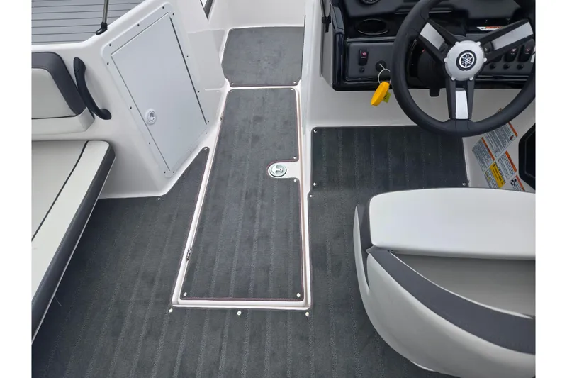 Slide: The Image of Interior view of 2025 Yamaha Boats AR190, showcasing sleek seating and steering wheel design. - 11