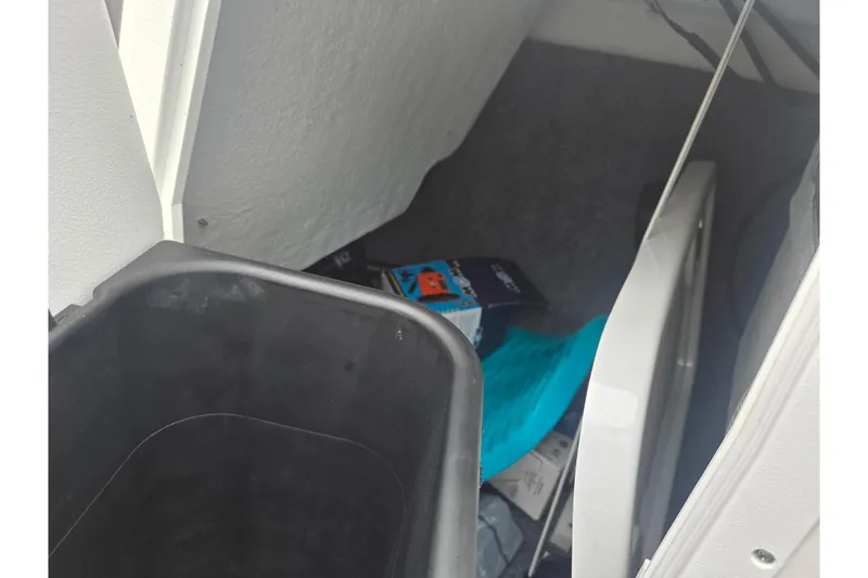 Slide: The Image of Storage compartment of 2025 Yamaha Boats AR190 with various items inside. - 15