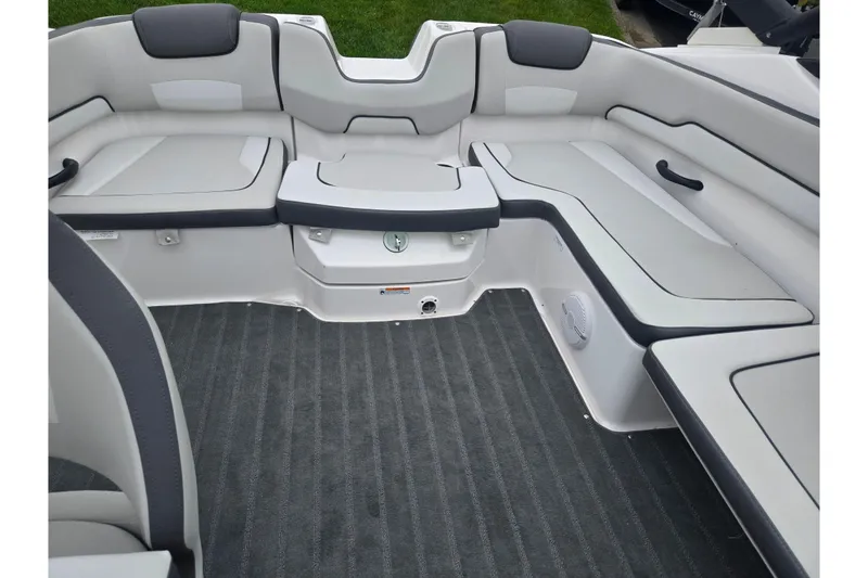 Slide: The Image of 2025 Yamaha Boats AR190 interior seating with gray upholstery and carpeted flooring. - 21