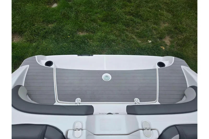 Slide: The Image of 2025 Yamaha Boats AR190 swim platform with cup holders and cushioned seating. - 24