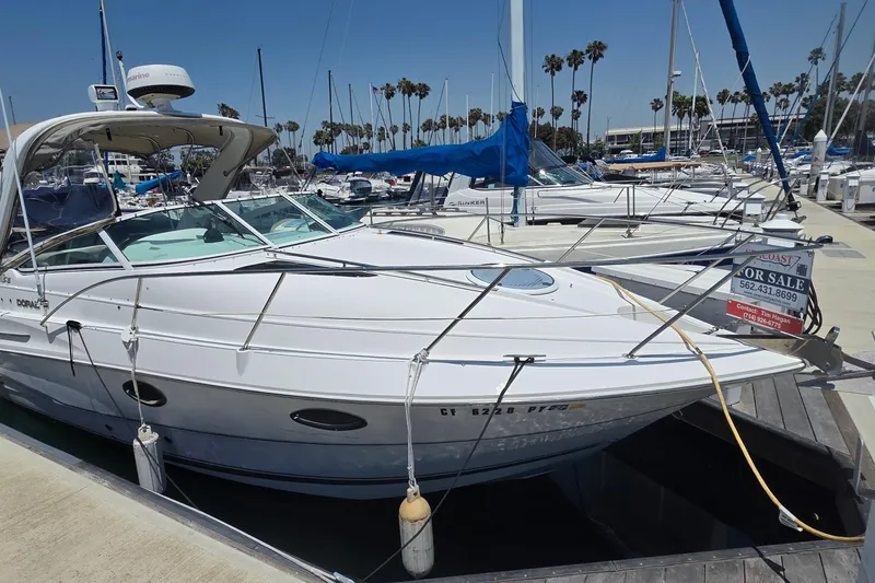 The Image of 2001 Doral 250se boat docked at marina, for sale sign visible. - 0