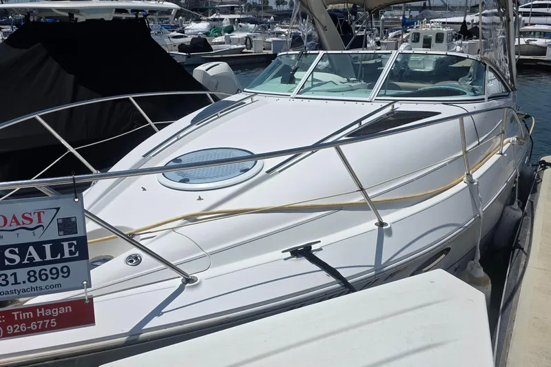 Slide: The Image of 2001 Doral 250se boat for sale at marina, featuring sleek white design. - 1