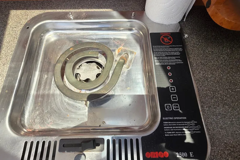 Slide: The Image of Electric stove on a 2001 Doral 250se boat, featuring a single coil burner. - 13