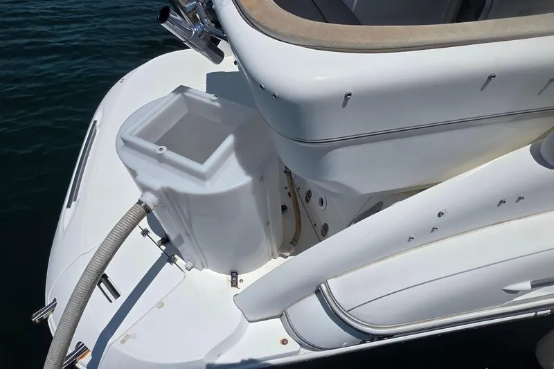Slide: The Image of Rear view of a 2001 Doral 250se boat, showcasing deck details and water hose. - 16