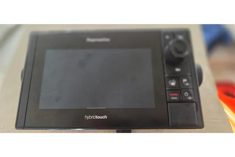 Slide: The Image of Raymarine HybridTouch marine display on a 2001 Doral 250se boat dashboard. - 21
