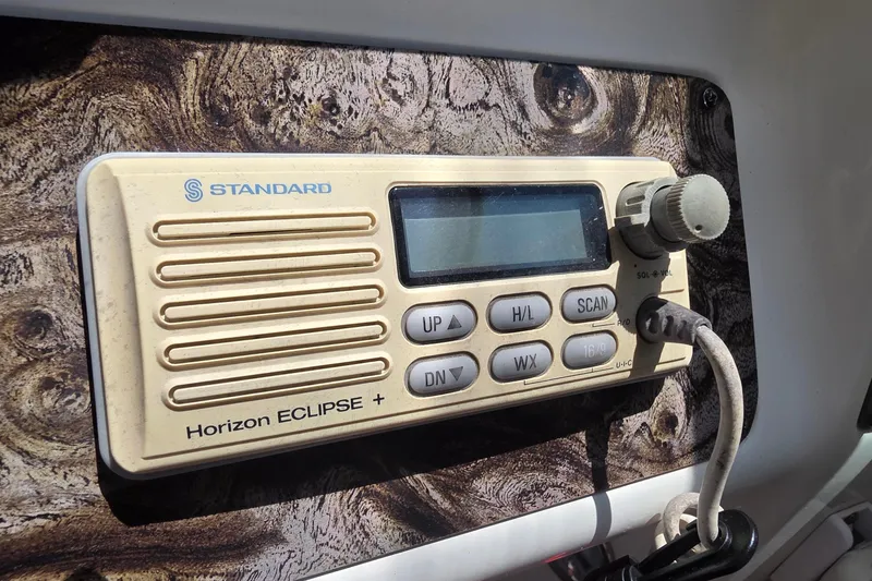 Slide: The Image of Standard Horizon Eclipse+ radio on a 2001 Doral 250se boat dashboard. - 23