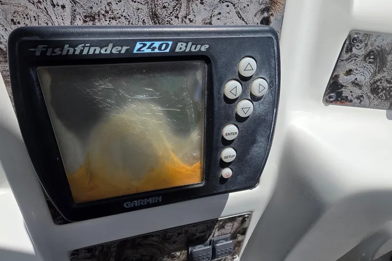 Slide: The Image of Fishfinder 240 Blue device on a 2001 Doral 250se boat dashboard. - 24