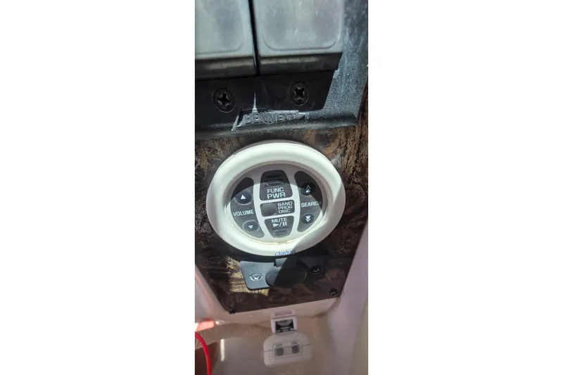 Slide: The Image of Control panel of a 2001 Doral 250se boat with volume and function buttons. - 25
