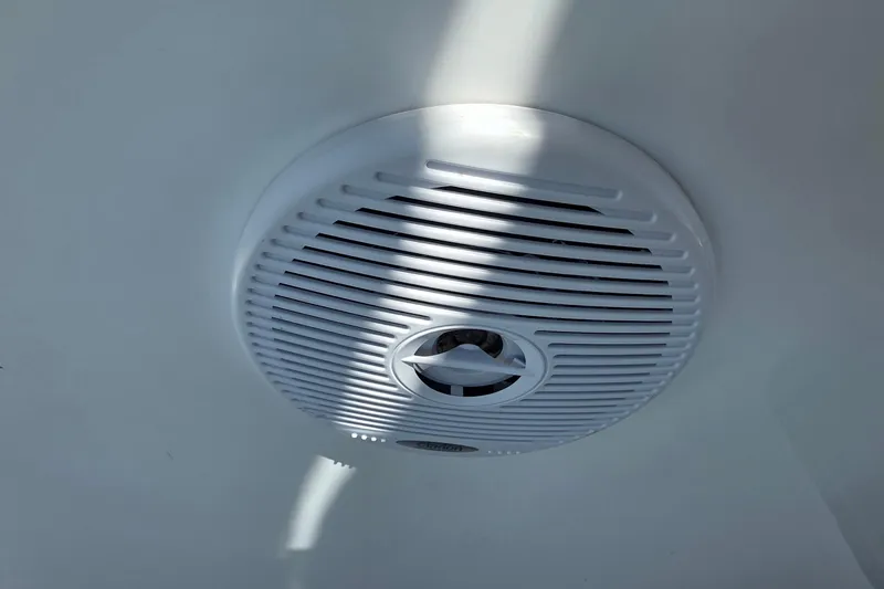 Slide: The Image of White speaker on a 2001 Doral 250se boat ceiling, illuminated by sunlight. - 27