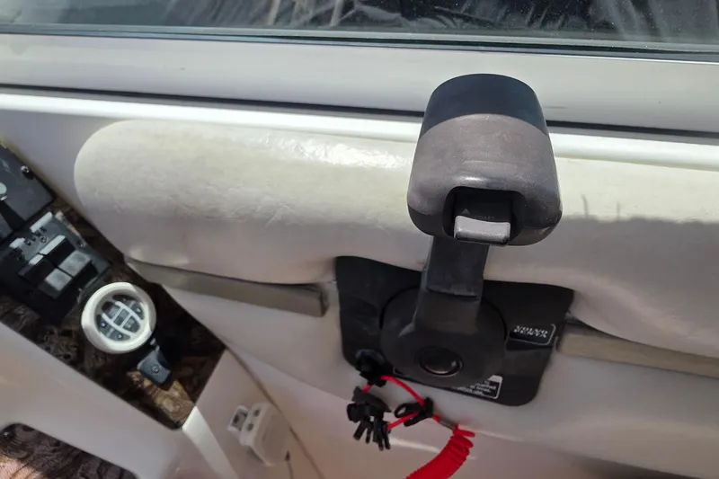 Slide: The Image of Throttle control and gauge on a 2001 Doral 250se boat dashboard. - 28
