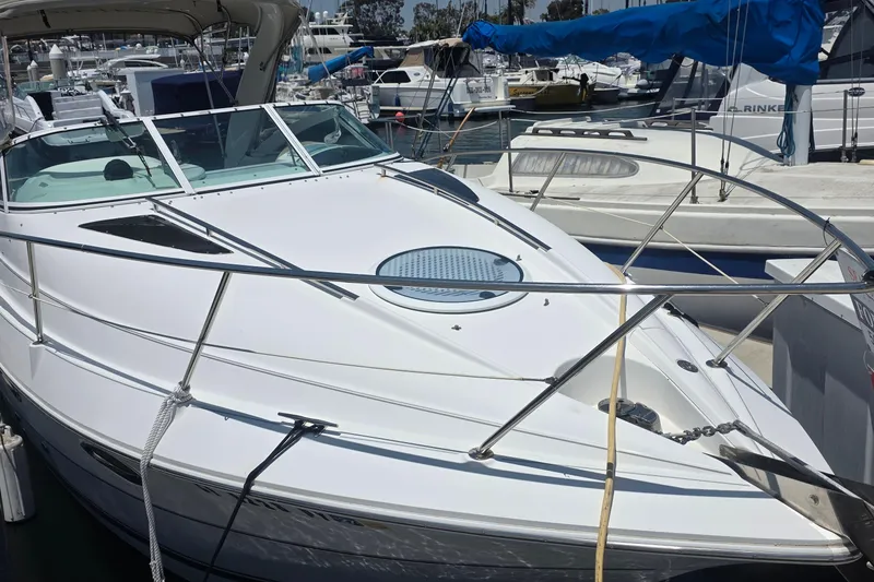 Slide: The Image of 2001 Doral 250se boat docked at a marina, featuring sleek white design and spacious deck. - 3