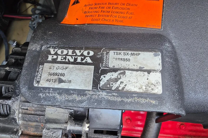 Slide: The Image of Volvo Penta engine label on a 2001 Doral 250se boat, showing model and safety warning. - 31