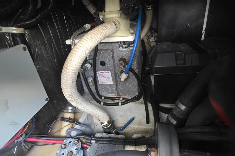 Slide: The Image of Engine compartment of a 2001 Doral 250se boat, showing hoses and components. - 34