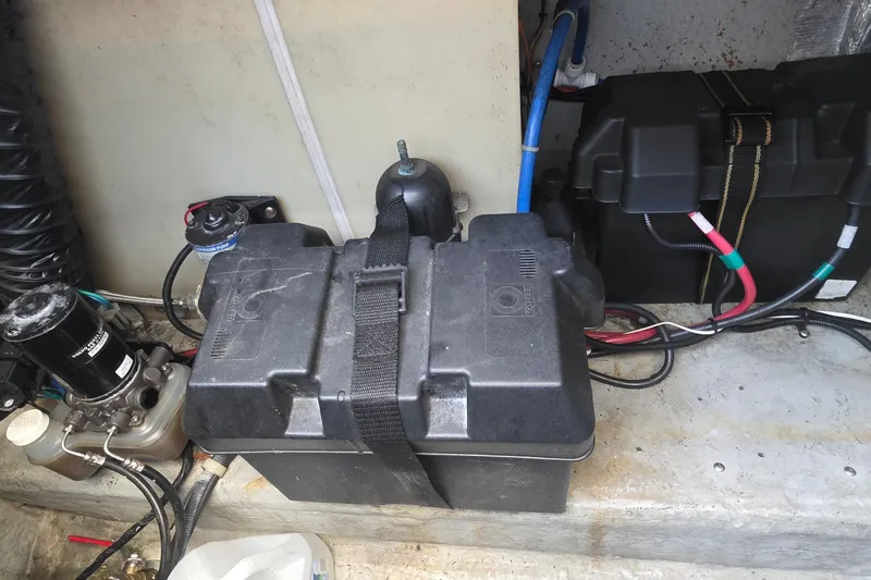 Slide: The Image of Battery compartment of a 2001 Doral 250se boat with wiring and components. - 35