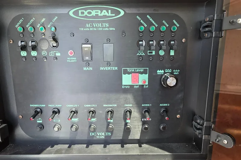 Slide: The Image of Control panel of a 2001 Doral 250se boat, featuring various switches and indicators. - 36