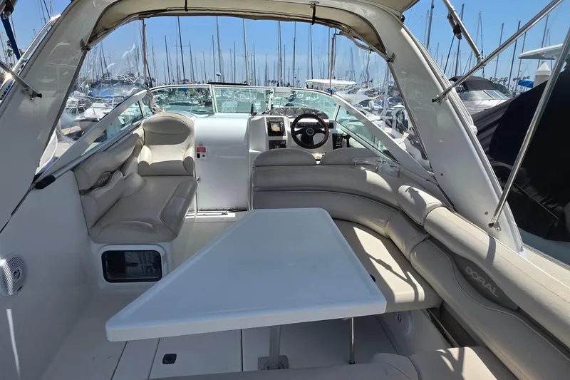 Slide: The Image of Interior of a 2001 Doral 250se boat with seating and steering wheel. - 4
