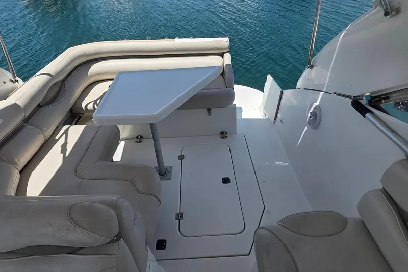 Slide: The Image of Interior of a 2001 Doral 250se boat with seating and table on calm water. - 5