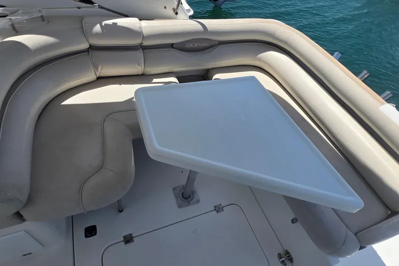 Slide: The Image of Luxurious seating area on a 2001 Doral 250se boat with a white table. - 6