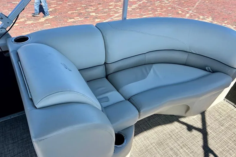 Slide: The Image of 2023 Cypress Cay Seabreeze 232 boat interior with plush seating and cup holder. - 18