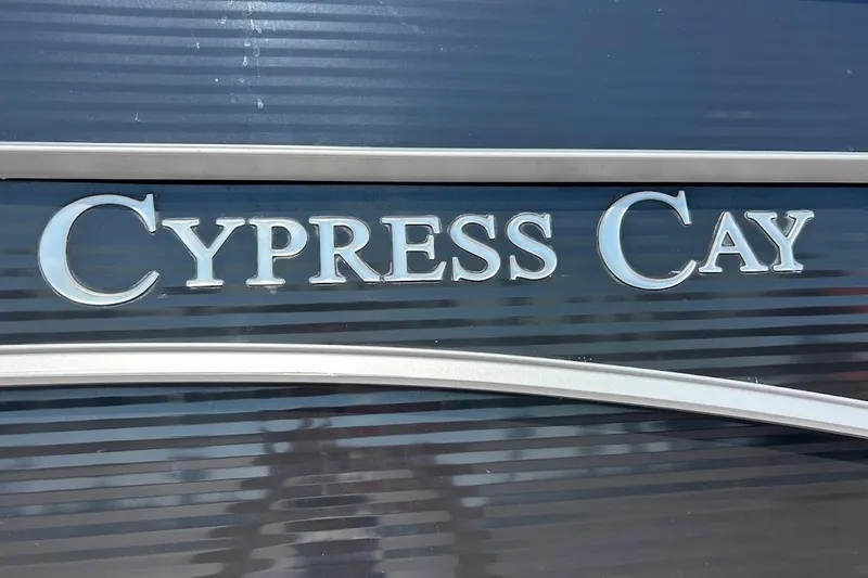 Slide: The Image of 2023 Cypress Cay Seabreeze 232 boat logo on sleek dark surface. - 26
