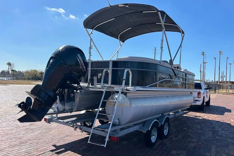 Slide: The Image of 2023 Cypress Cay Seabreeze 232 pontoon boat on trailer, with Mercury outboard motor. - 4