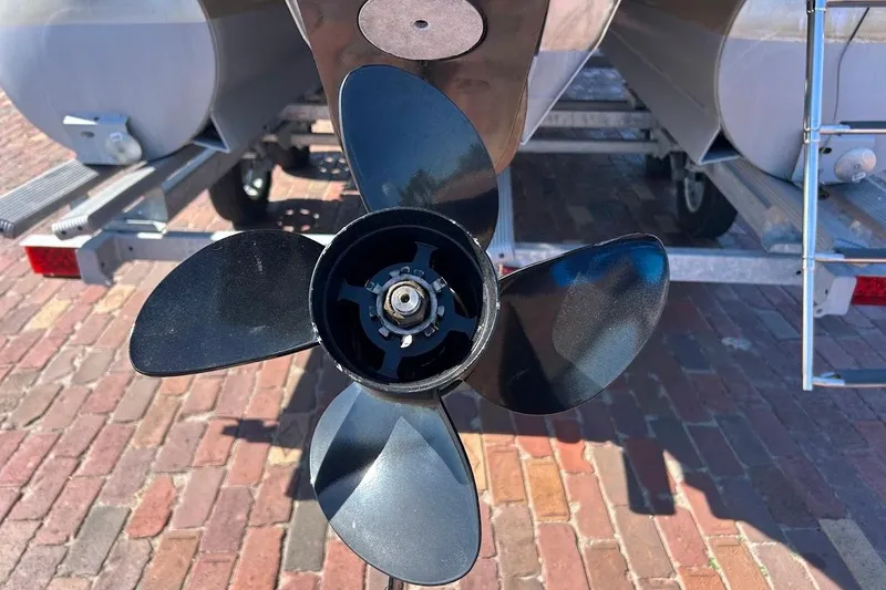 Slide: The Image of Close-up of a 2023 Cypress Cay Seabreeze 232 boat propeller on a brick surface. - 9