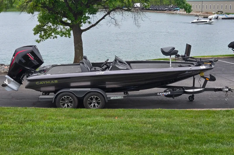 The Image of 2022 Caymas CX 19 boat on trailer by a lakeside, featuring sleek design and powerful engine. - 0