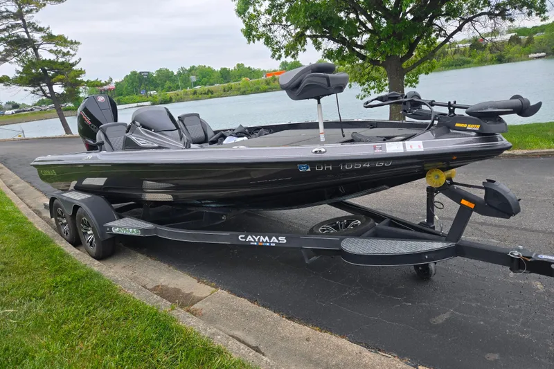 Slide: The Image of 2022 Caymas CX 19 boat on trailer by a lakeside road. - 10