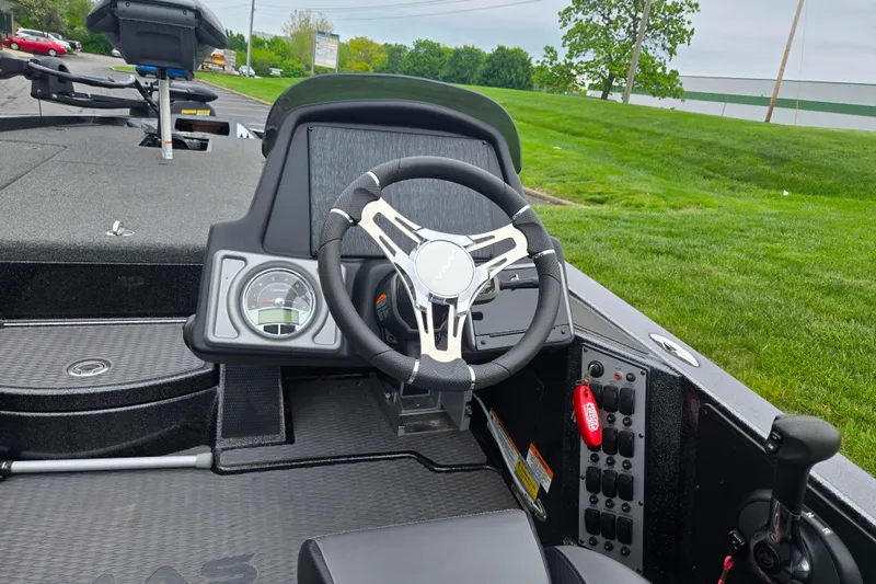Slide: The Image of 2022 Caymas CX 19 boat cockpit with steering wheel and control panel. - 13
