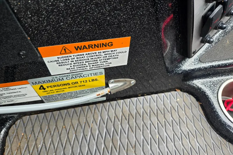 Slide: The Image of Warning labels on 2022 Caymas CX 19 boat, indicating maximum capacity and safety instructions. - 14
